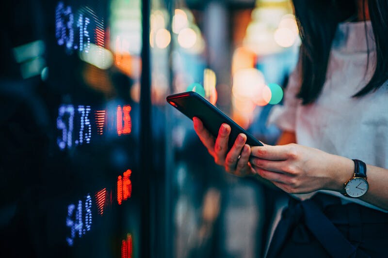 Financial trading data on smartphone by the stock exchange market 
