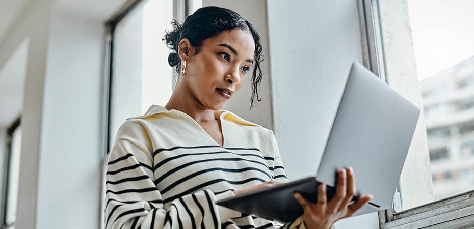 Black woman with laptop reading, typing and working for online digital newspaper, marketing or advertising company. Girl check email, post blog feedback or review social media content writing article