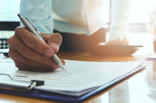 Businessman writing or pointing on report paper. Business strategy concept.