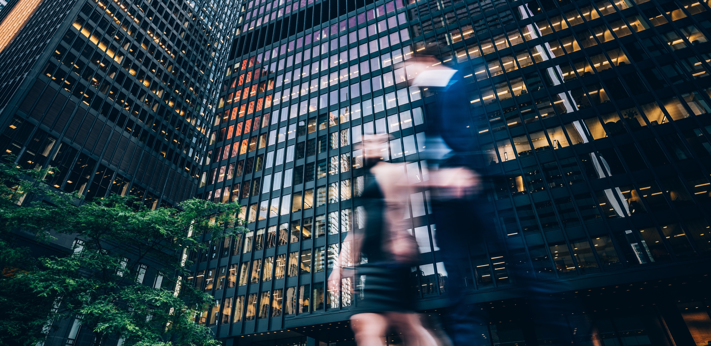 low angle view of office building with people walking by